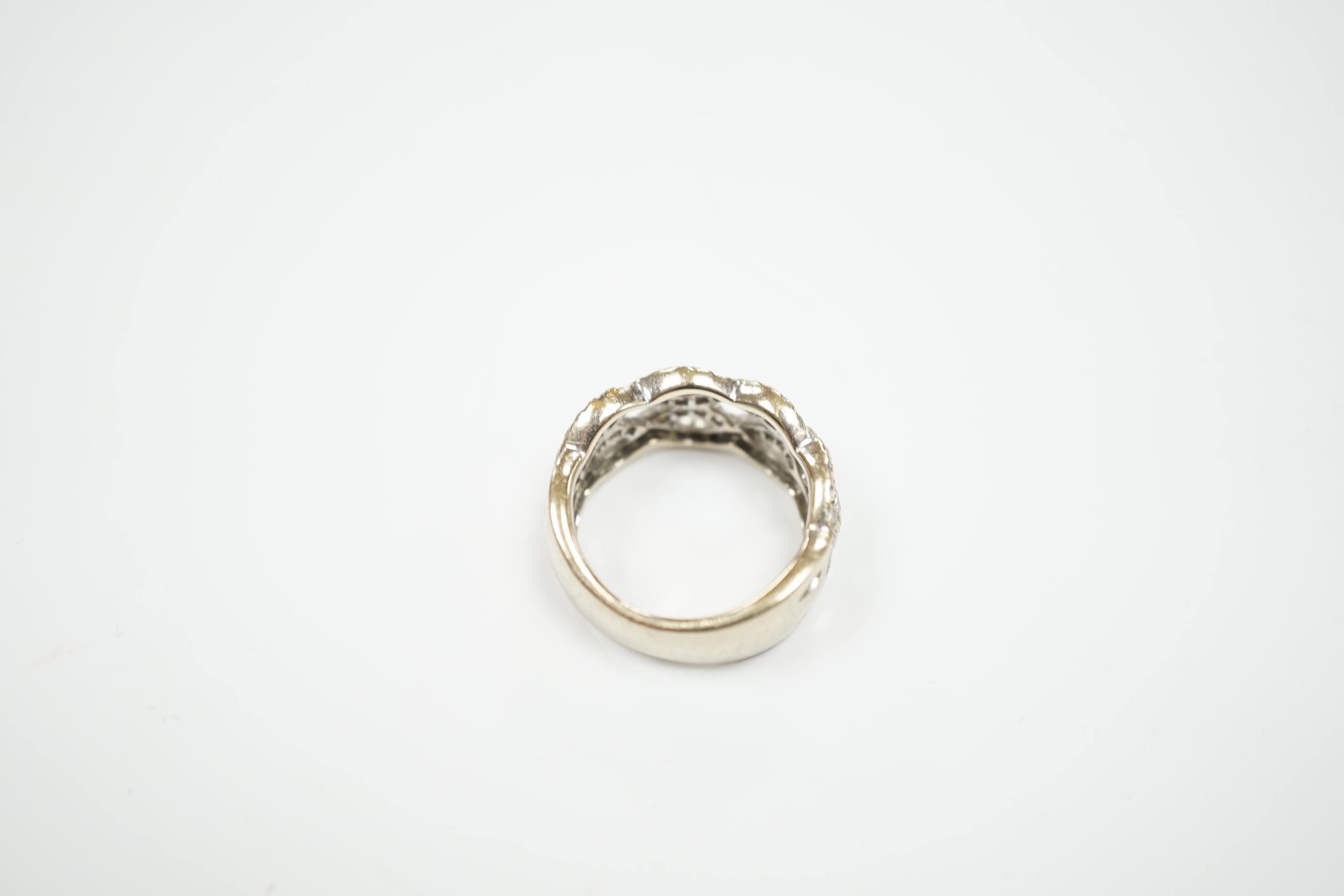 A modern 14k white metal and diamond chip cluster set dress ring, of interwoven design, size M, gross weight 6.4 grams.